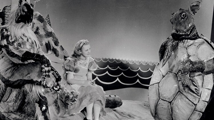 The plaintive wail of Cary Grant, the Mock Turtle, as he pours out his sad lament to Alice (Charlotte Henry) while William Austin in his Gryphon costume.